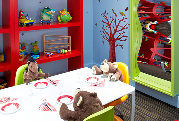 The children's room sits ready with toys and stuffed animals for kids to enjoy.