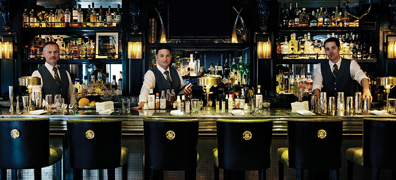 Refined bartenders stand ready to serve drinks at the Dancing Bear Aspen.