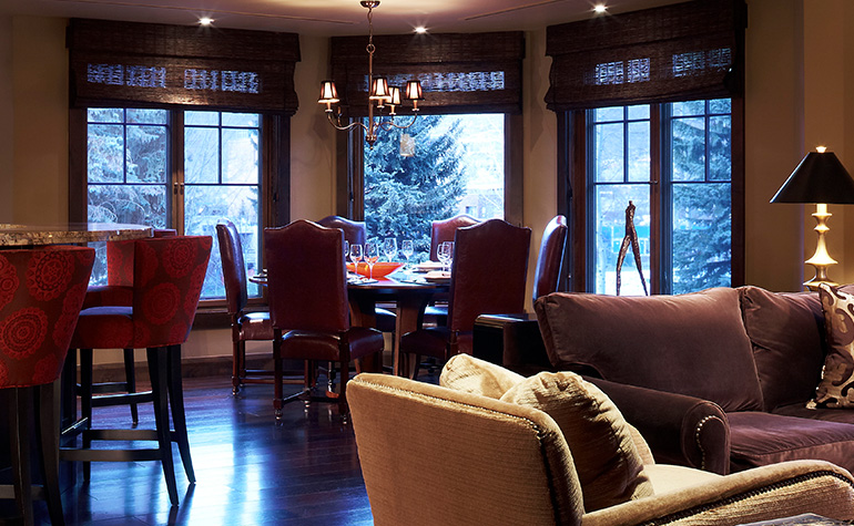 A luxury party room hosts an event about how to own Aspen real estate.